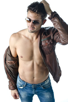 Handsome young man wearing leather jacket on naked torso