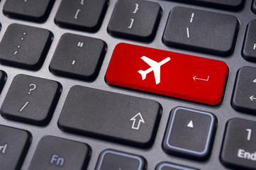 online booking of flight ticket, with plane sign on keyboard