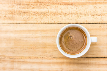 coffee in white cup on wood background