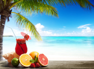 strawberry cocktail and tropical fruit on the beach