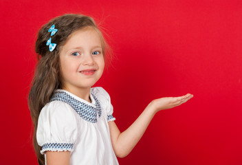 girl on red showing something on the palm