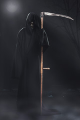 death with scythe standing at night