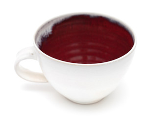 cup with white exterior and red interior isolated