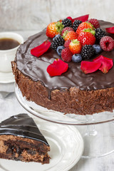 Chocolate cake with strawberries. Birthday party table, wood
