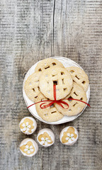 Top view of cookies with red bow on white wooden table