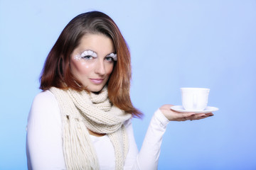 Winter makeup woman with cup of hot beverge