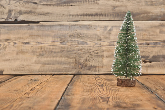 Little toy christmas tree on old wooden table
