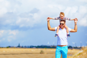 happy father and son in summer day