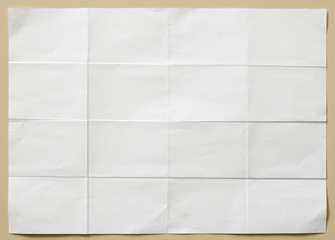 white textured sheet of paper folded in sixteen  part