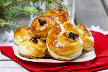 Traditional swedish buns in christmas setting. A saffron bun