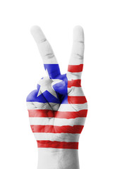 Hand making the V sign, Liberia flag painted