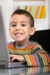 funny little boy with  laptop