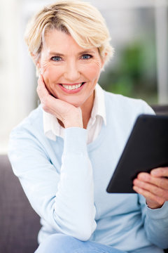 middle aged woman holding tablet pc