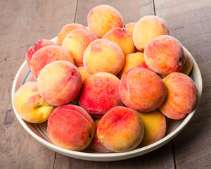 Bowl of fresh yellow peaches