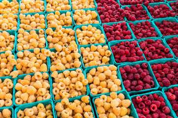 red and yellow raspberries in boxes