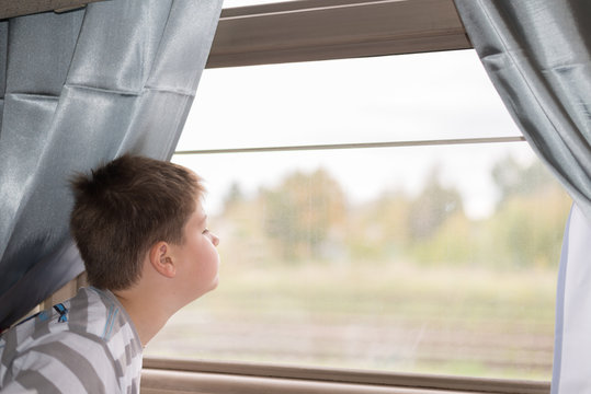 The Boy Looks In Train Window