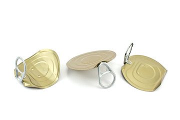Three tin can lids with opener isolated on white