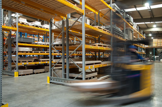 A forklift driving through a warehouse