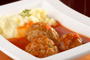 Selective focus on the meat balls and mashed potato
