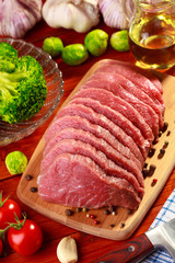 Raw beef and vegetables on wood