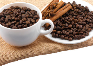 Cup with coffee beans and cinnamon