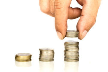 A stack coins with hand of someone isolated on white