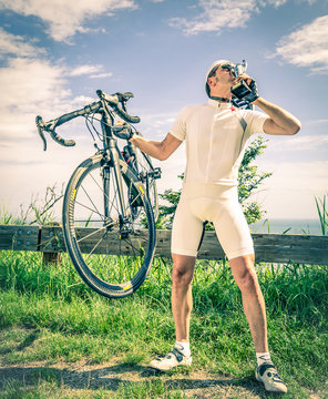 Winner of a Bike Race kissing the Trophy