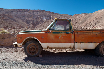 Rusty, rundown, abandoned car on the deserted road