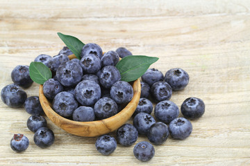 Blueberries in wooden bowl with copy space