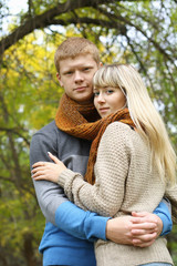 young couple together in love hugging in autumn