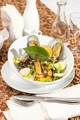 salad with vegetables and seafood on the table in a restaurant