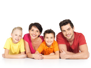happy family with two children lying on white floor