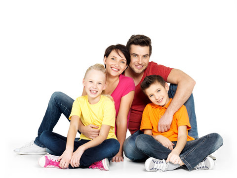 happy  family with two children sitting on white floor