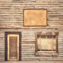 Naklejka premium Western vintage wooden facade. Door, window and blank board