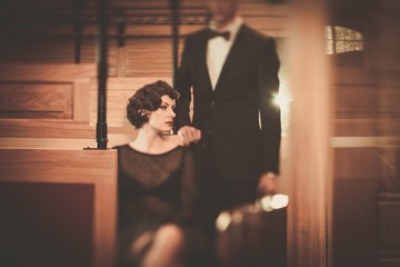 Beautiful vintage style couple inside retro train coach