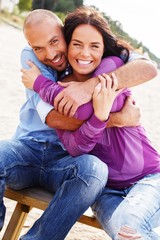 Happy smiling middle-aged couple on a beach