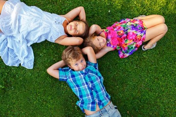Happy children lying on a meadow