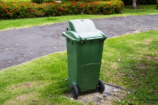 Green trash can in the park