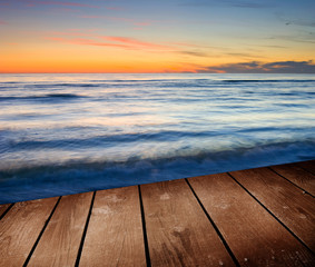 Fototapeta na wymiar Sunset and empty wooden deck table.