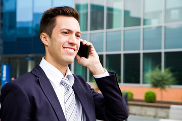 Portrait of a young businessman talking on the phone