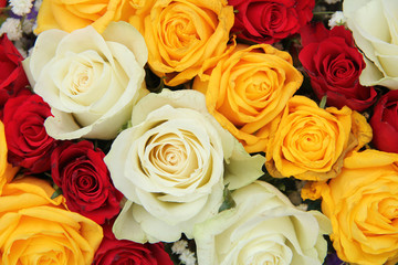 Yellow, white and red roses in a wedding arrangement