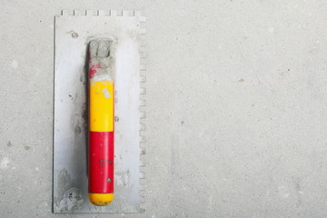 building worktool dirty trowel on rough concrete surface