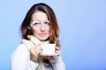 Winter makeup woman with cup of hot latte coffee