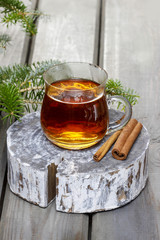 Glass of hot tea on wooden background. Copy space.