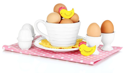 Eggs in different crockery isolated on white
