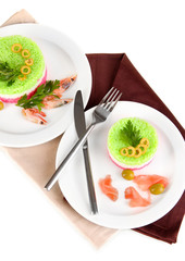 Colored rice on plates on napkin isolated on white