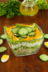 Delicious salad with eggs, cabbage and cucumbers on wooden