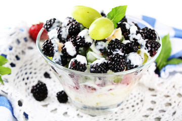 Fruit salad in glass bowl, isolated on white