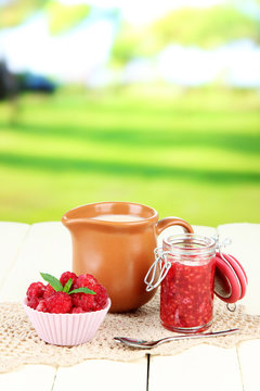 Fresh raspberry, raspberry jam and cream in jug