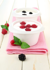 Delicious yogurt with berries on table close-up